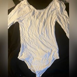 White bodysuit with lace pattern on collar